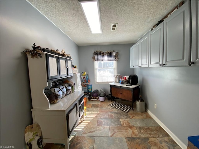 clothes washing area featuring a textured ceiling