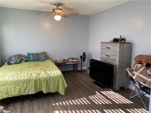 bedroom with dark hardwood / wood-style flooring and ceiling fan