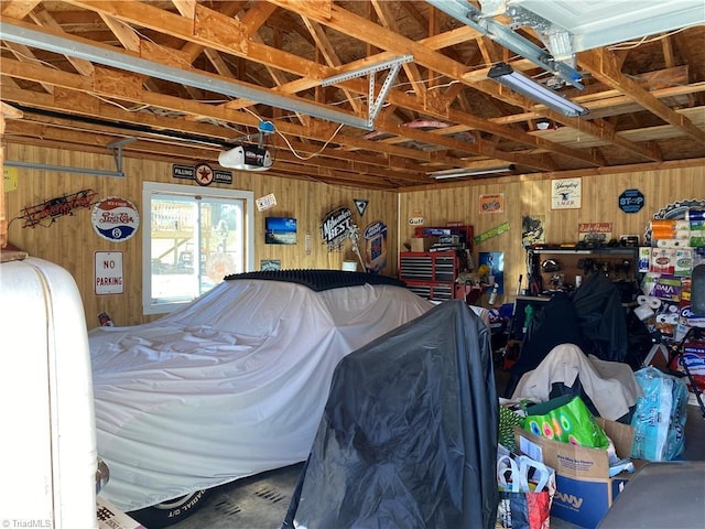 garage with wooden walls and a garage door opener