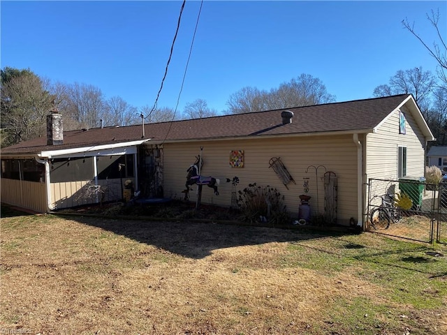 back of house featuring a lawn