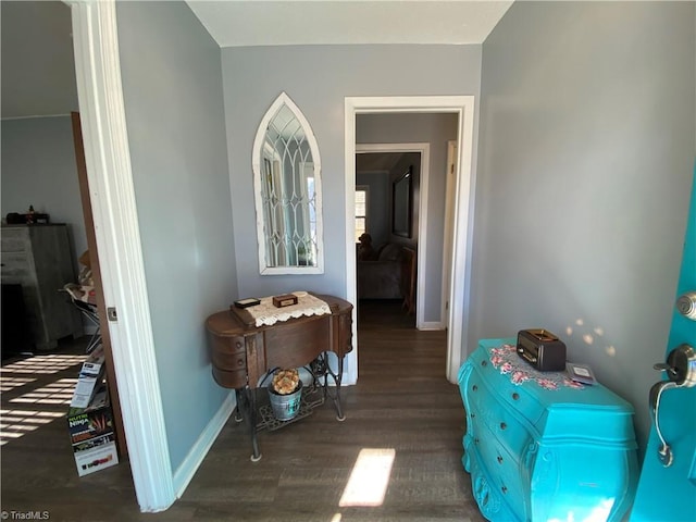 hallway with dark hardwood / wood-style flooring