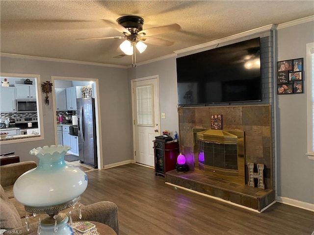 living room with a textured ceiling, crown molding, ceiling fan, and dark hardwood / wood-style floors