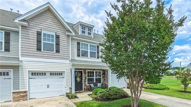 104 Tilleys Grove Dr, Kernersville, NC 27284 - view of front of property featuring concrete driveway, an attached garage, stone siding, and a front yard