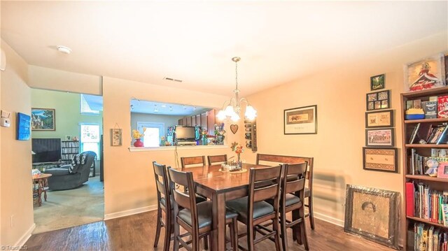 104 Tilleys Grove Dr, Kernersville, NC 27284 - dining room featuring wood finished floors and a chandelier