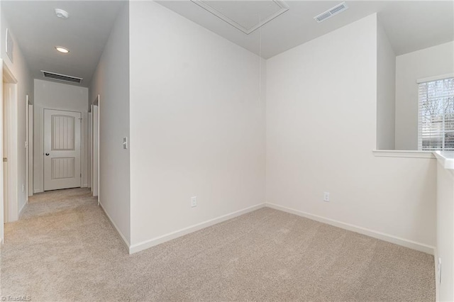 unfurnished room featuring light colored carpet