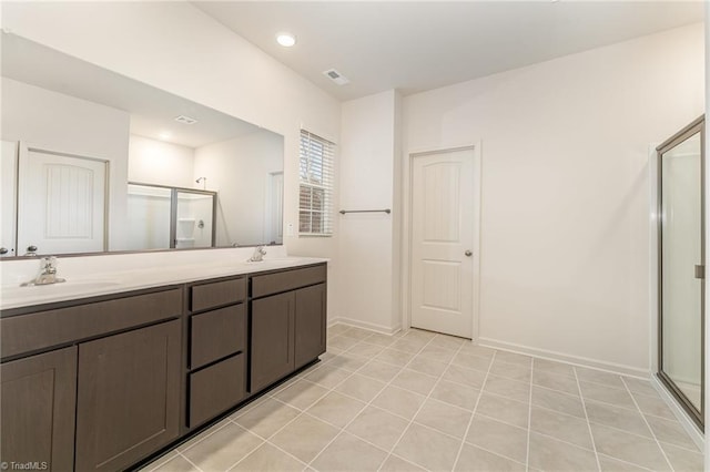 bathroom featuring vanity, an enclosed shower, and tile patterned floors