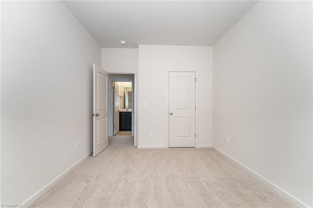 unfurnished bedroom featuring light carpet