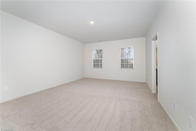 unfurnished room featuring light carpet