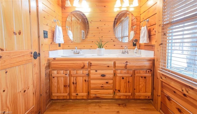 bathroom with vanity, hardwood / wood-style flooring, and wooden walls