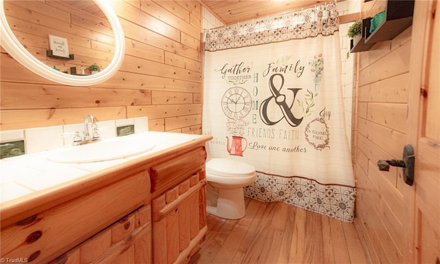 bathroom with hardwood / wood-style floors, wooden ceiling, toilet, and wooden walls