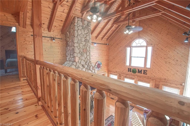 interior space with vaulted ceiling with beams, wood walls, hardwood / wood-style floors, and wooden ceiling