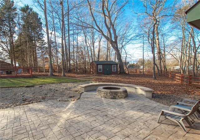 view of patio / terrace featuring a fire pit and a storage unit