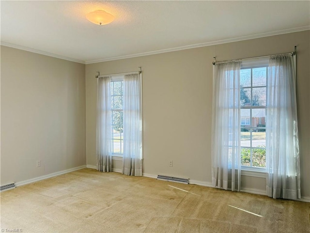 carpeted spare room with baseboards, visible vents, and ornamental molding