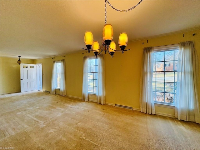 empty room with an inviting chandelier, baseboards, ornamental molding, and light colored carpet