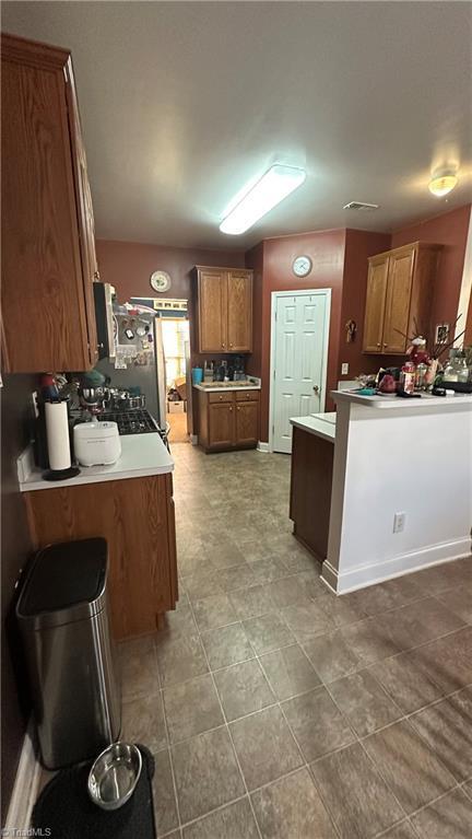 kitchen with stainless steel fridge, stove, and kitchen peninsula