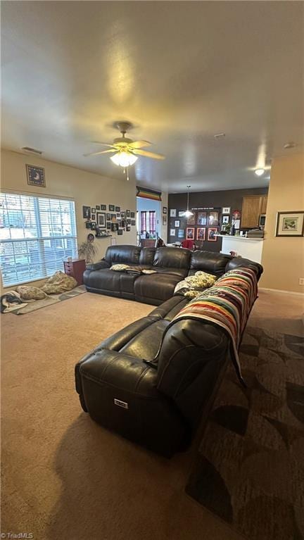 carpeted living room with ceiling fan