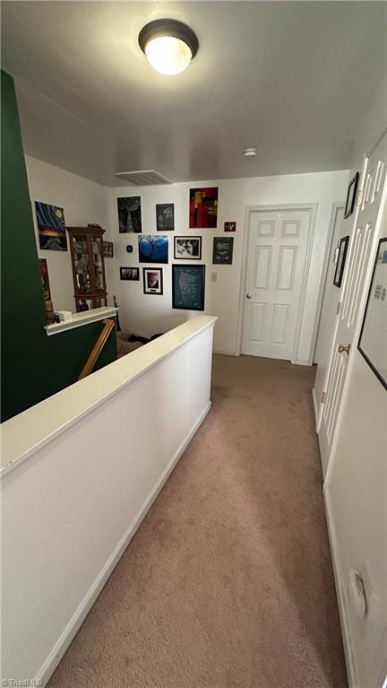 hallway with light carpet