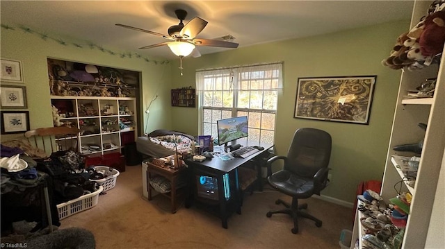 carpeted home office featuring ceiling fan