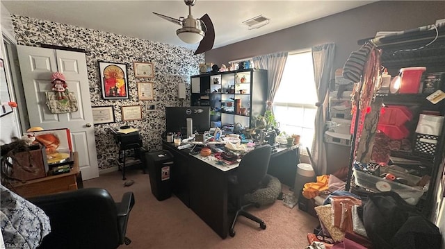 carpeted home office featuring ceiling fan