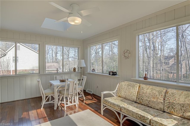 sunroom featuring ceiling fan