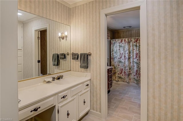 full bathroom with wallpapered walls, curtained shower, crown molding, and vanity