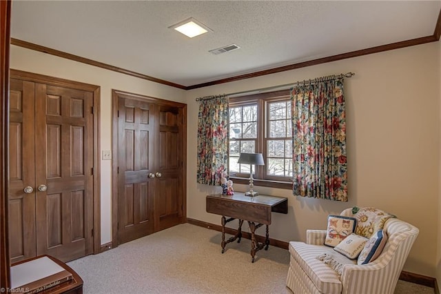 sitting room with baseboards, visible vents, carpet, a textured ceiling, and crown molding