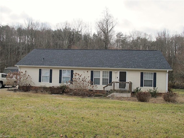 ranch-style home with a front lawn and a shingled roof