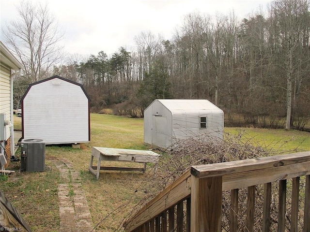 view of yard with central AC unit and a storage unit