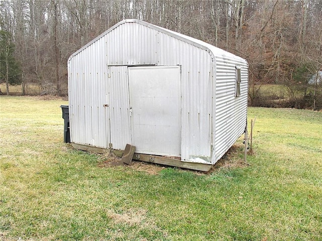 view of outdoor structure featuring a lawn