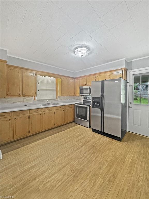 964 Mountain View Rd, North Wilkesboro, NC 28659 - kitchen featuring appliances with stainless steel finishes, a sink, light wood-style floors, light countertops, and crown molding