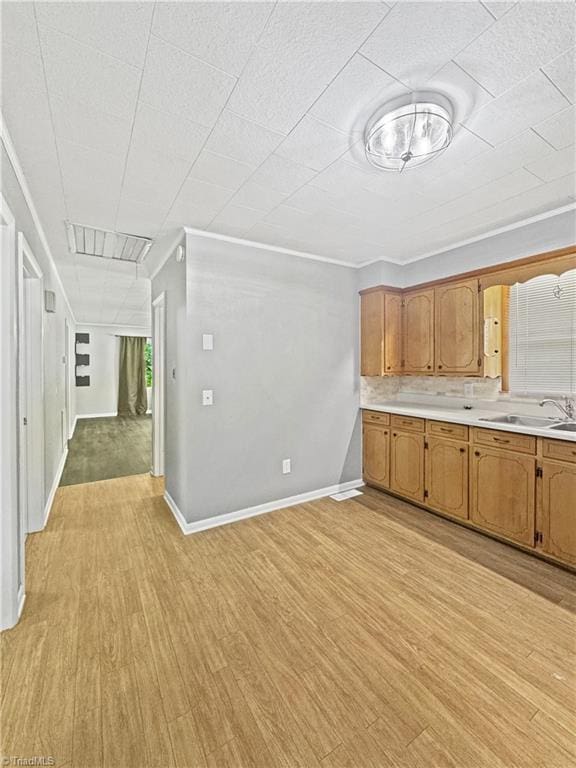 964 Mountain View Rd, North Wilkesboro, NC 28659 - kitchen with a sink, light wood finished floors, light countertops, ornamental molding, and baseboards