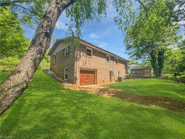 964 Mountain View Rd, North Wilkesboro, NC 28659 - view of property exterior featuring brick siding, central AC, a garage, and a lawn