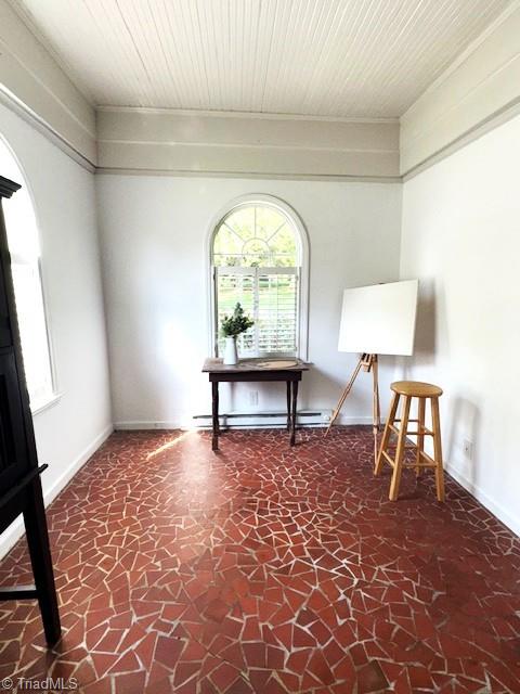 interior space with wooden ceiling and a baseboard radiator