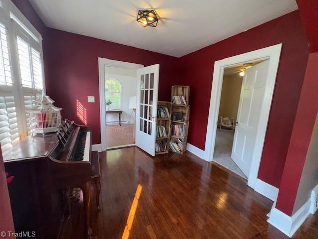 dining room featuring baseboards, ceiling fan, french doors, and wood finished floors