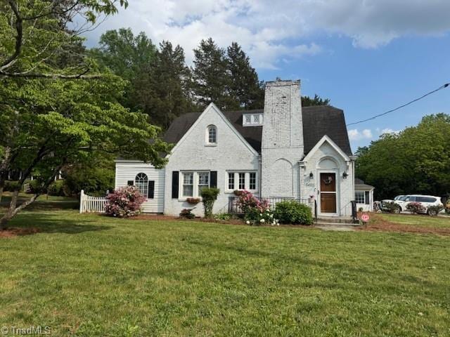 rear view of property with a lawn and a chimney