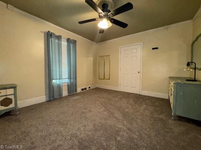 interior space with baseboards, crown molding, ceiling fan, and visible vents