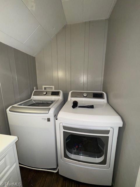 washroom with laundry area, dark wood finished floors, and washer and clothes dryer