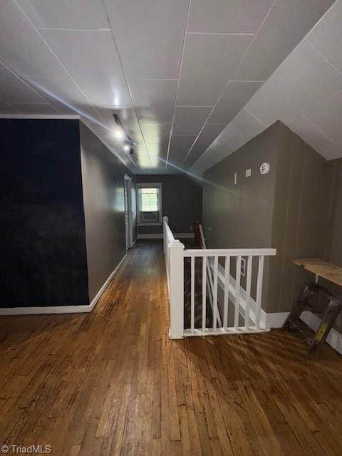 additional living space featuring wood-type flooring and lofted ceiling