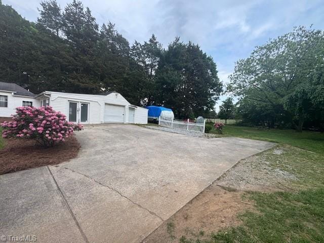 view of property exterior featuring an attached garage and aphalt driveway