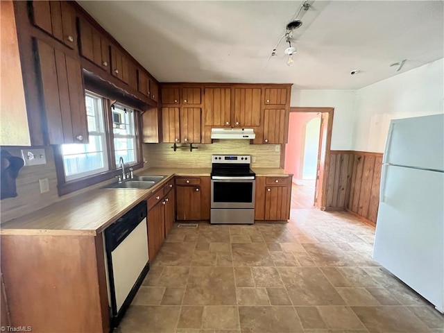 1716 US Highway 220, Stokesdale, NC 27357 - kitchen with white appliances, under cabinet range hood, a sink, light countertops, and tasteful backsplash