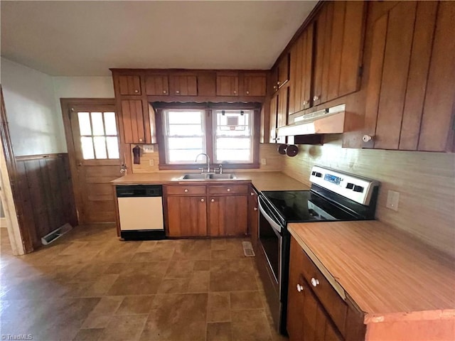 1716 US Highway 220, Stokesdale, NC 27357 - kitchen with white dishwasher, a sink, electric range, under cabinet range hood, and brown cabinetry