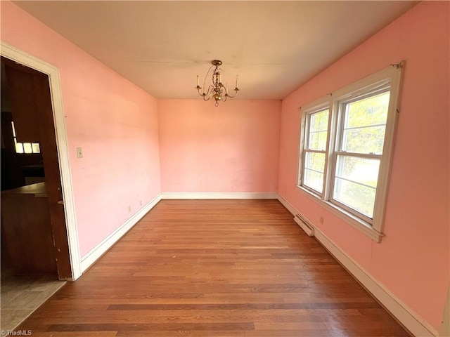 1716 US Highway 220, Stokesdale, NC 27357 - unfurnished dining area featuring wood finished floors, a chandelier, and baseboards