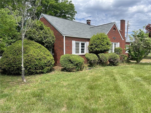 1716 US Highway 220, Stokesdale, NC 27357 - view of property exterior with brick siding, a yard, a chimney, and a shingled roof