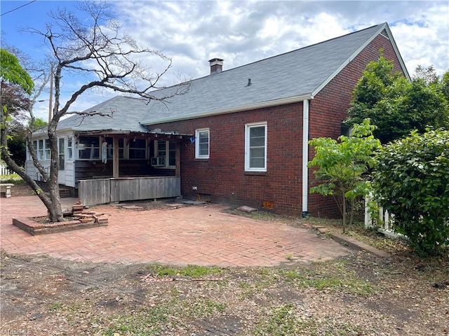 1716 US Highway 220, Stokesdale, NC 27357 - rear view of house with brick siding, a patio, crawl space, a chimney, and roof with shingles