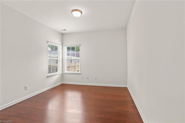 empty room featuring dark hardwood / wood-style flooring