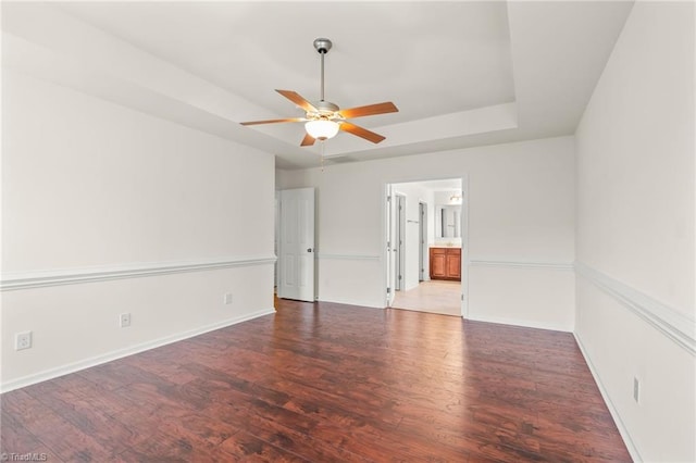 4887 Old Towne Village Cir, Pfafftown, NC 27040 - unfurnished room featuring a raised ceiling, baseboards, a ceiling fan, and wood finished floors