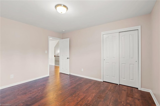 4887 Old Towne Village Cir, Pfafftown, NC 27040 - unfurnished bedroom featuring baseboards, wood finished floors, and a closet