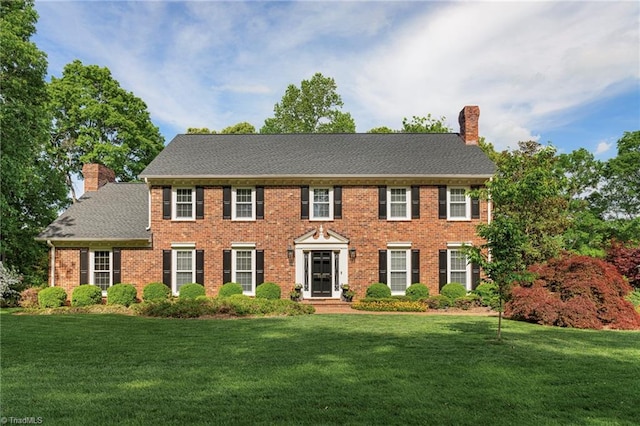 5001 Edinborough Rd, Greensboro, NC 27406 - colonial inspired home featuring a front yard, brick siding, and a chimney