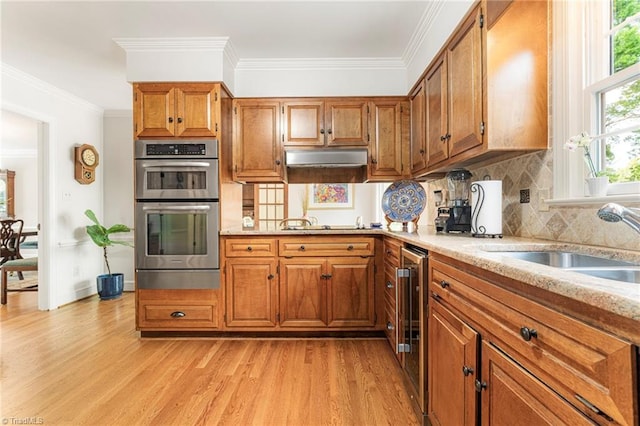 5001 Edinborough Rd, Greensboro, NC 27406 - kitchen featuring double oven, light wood-style flooring, and brown cabinetry