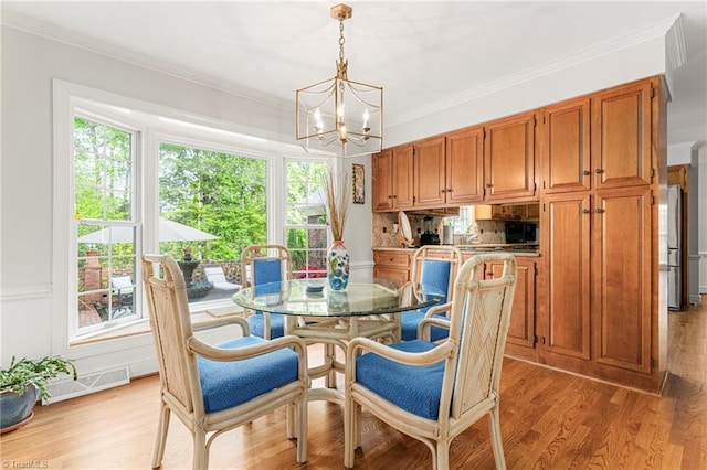 5001 Edinborough Rd, Greensboro, NC 27406 - dining area featuring visible vents, plenty of natural light, a notable chandelier, and crown molding